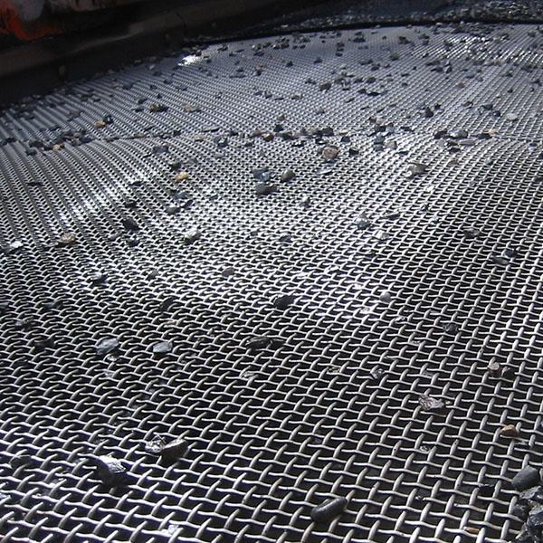 crimped wire mesh panel installed in a vibrating screen machine at a quarry